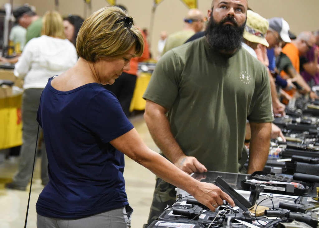 US-SOCIETY-CULTURE-GUNS A gun enthusiast holds a weapon during the South Florida Gun Show at Dade County Youth Fairgrounds in Miami, Florida, on February 17, 2018.
