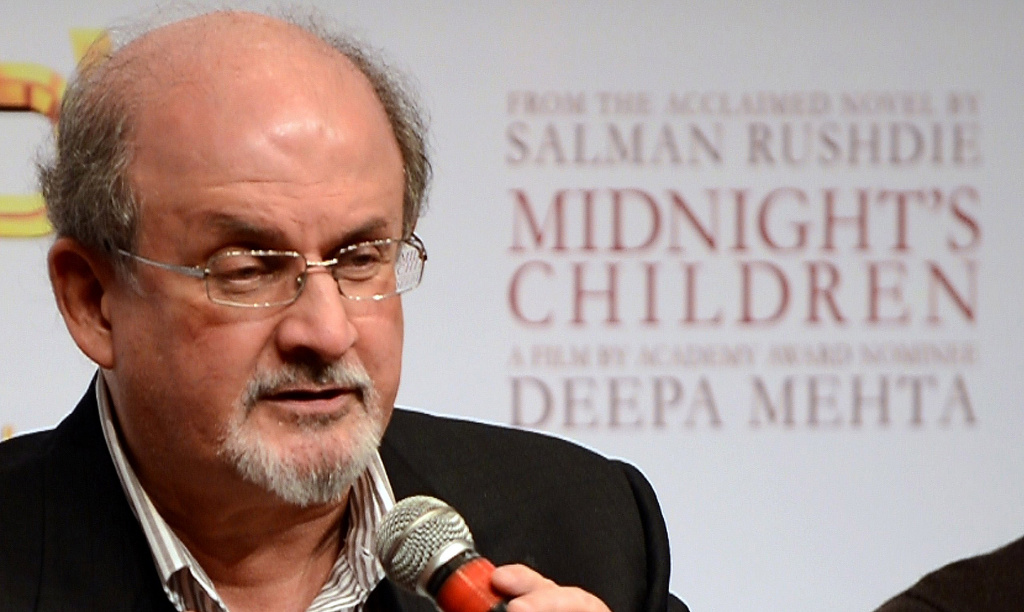 INDIA-LITERATURE-RELIGION-PEOPLE Indian born British author Salman Rushdie looks on at a function to promote the film 'Midnight's Children' in Mumbai on January 29, 2013, just prior to its release in India on February 1. Directed by Deepa Mehta, the film is based on Rushdie's Booker Prize-winning novel 'Midnight's Children',” which he also adapted for the screen.