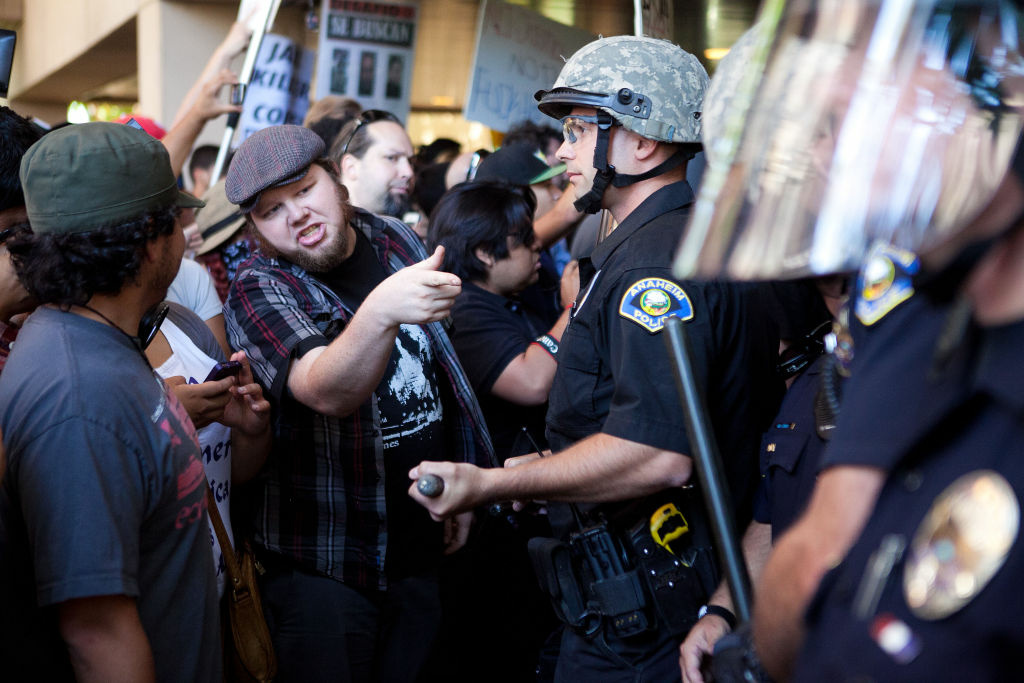Anaheim Residents Protest Police Shootings Over Weekend ANAHEIM, CA - JULY 24: Protesters clash with police at Anaheim City Hall to show their outrage for the shooting death of Manuel Angel Diaz, 25, on July 24, 2012 in Anaheim, California. Diaz was fatally shot July 21 by an Anaheim police officer and has sparked days of protests by the angered community. (Photo by Jonathan Gibby/Getty Images)