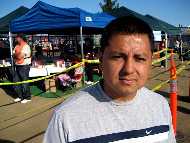 Yoshio Moncada stands in front of the Kern County Public Health Department's makeshift clinic at the swap meet on the county fairgrounds in Bakersfield, Calif. If the shots weren't available at the swap meet, Moncada says, he and his family wouldn't have gotten vaccinated.