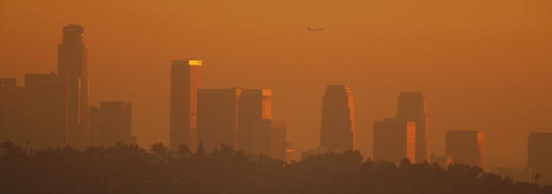 The Los Angeles downtown skyline is enveloped in smog shortly before sunset