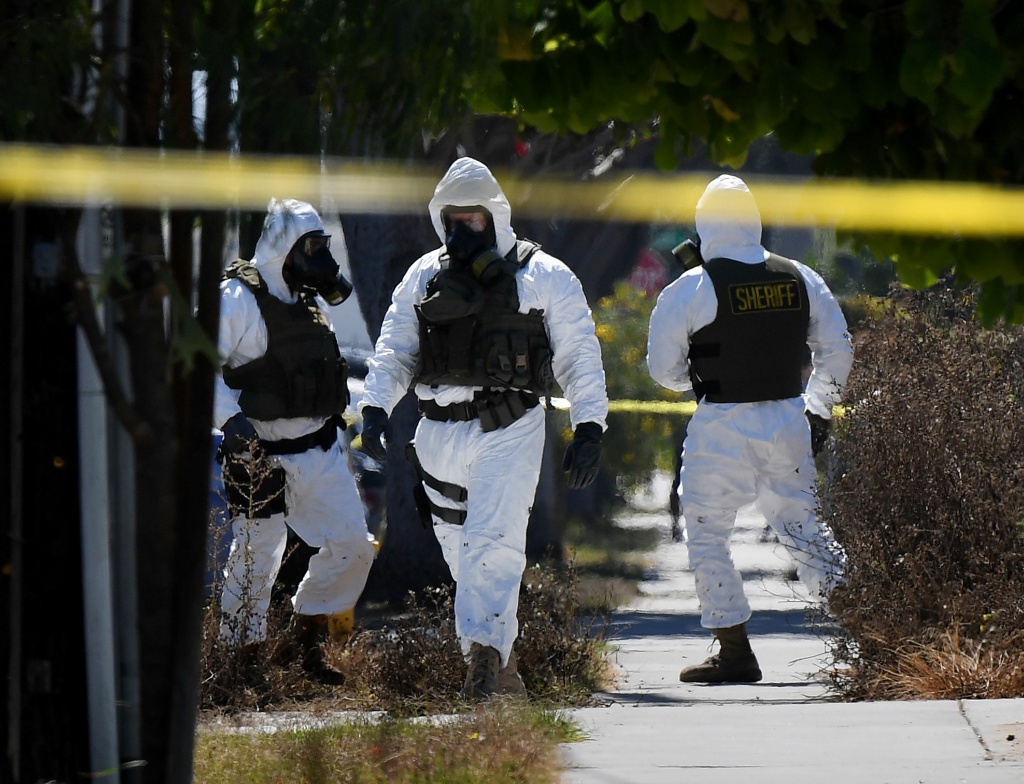 US-CRIME-POLICE-MUNITIONS Members of the Los Angeles County Sheriff's Department bomb and hazmat squad search a Lawndale house where several artillery shells and grenades were found on September 29, 2017.