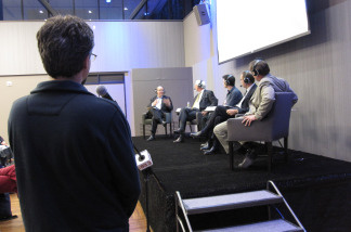 An audience members asks a question at the first public event held in the Crawford Family Forum.