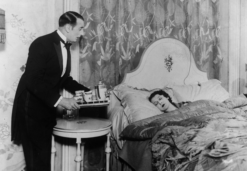 Room Service circa 1930: A butler brings his mistress breakfast in bed.