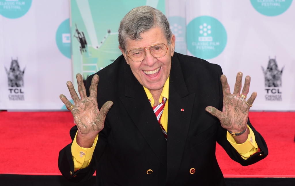 US-ENTERTAINMENT-LEWIS Jerry Lewis shows his hands after immortalizing his handprints and footprints at the TCL Theater in Hollywood, California on April 12, 2014.