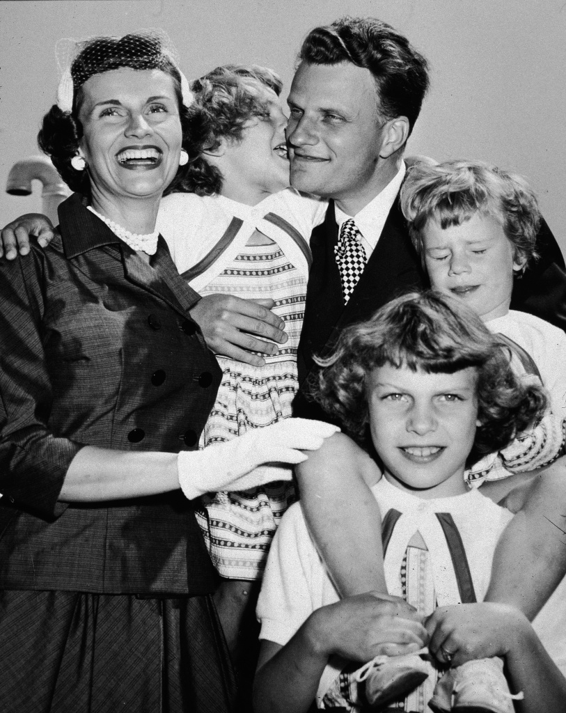 Billy Graham Reunites With Family After Tour American evangelist Billy Graham embraces his family upon his return from his 'Crusade for Christ' tour, New York, New York, mid 1950s. Clockwise from left: Chinese-born wife Ruth, daughter Anne, Graham, daughter Ruth (Bunny), and daughter Virginia.