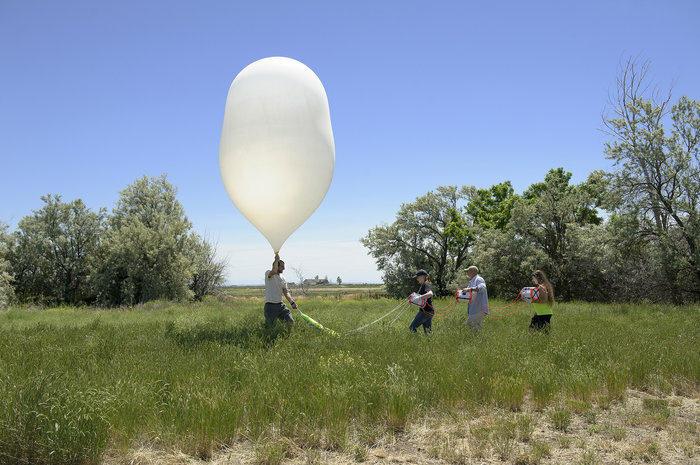balloon Montana State University Eclipse Ballooning Project team members (from left) Garrett Hilton, Katherine Lee, Berk Knighton and Micaela Moreni prepare to launch a high-altitude balloon during a test flight on June 22 near Rexburg, Idaho. During the Aug. 21 solar eclipse, teams across the nation will live-stream video footage of the eclipse as part of the MSU-led project.