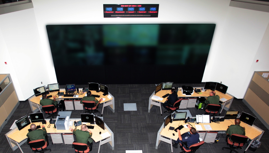 Customs and Border Protection Agents at the Joint Intelligence and Operations Coordination Center in Tucson. The content of the video display screens have been blurred for security reasons.
