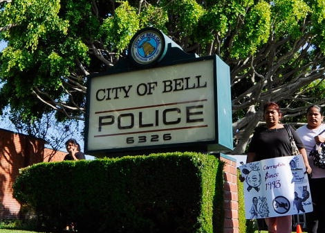 Mercer 10512 Residents of the City of Bell, holding protest placards are calling for the ouster of city officials arrive for the start of council meeting on July 26, 2010 in Bell, California.