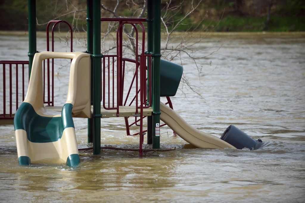 US-DAM-WEATHER A swing is seen partially submerged in flowing water at Riverbend Park in Oroville, California on February 13, 2017.