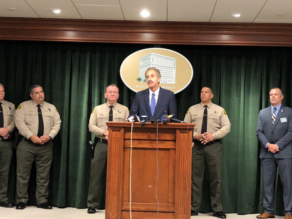 L.A. City Attorney Mike Feuer (at podium) joined Sheriff Jim McDonnell (to the left of Feuer) for the news conference announcing the new guidelines for inmates convicted of gun-related crimes. L.A. City Attorney Mike Feuer (at podium) joined Sheriff Jim McDonnell (to the left of Feuer) for the news conference announcing the new guidelines for inmates convicted of gun-related crimes.
