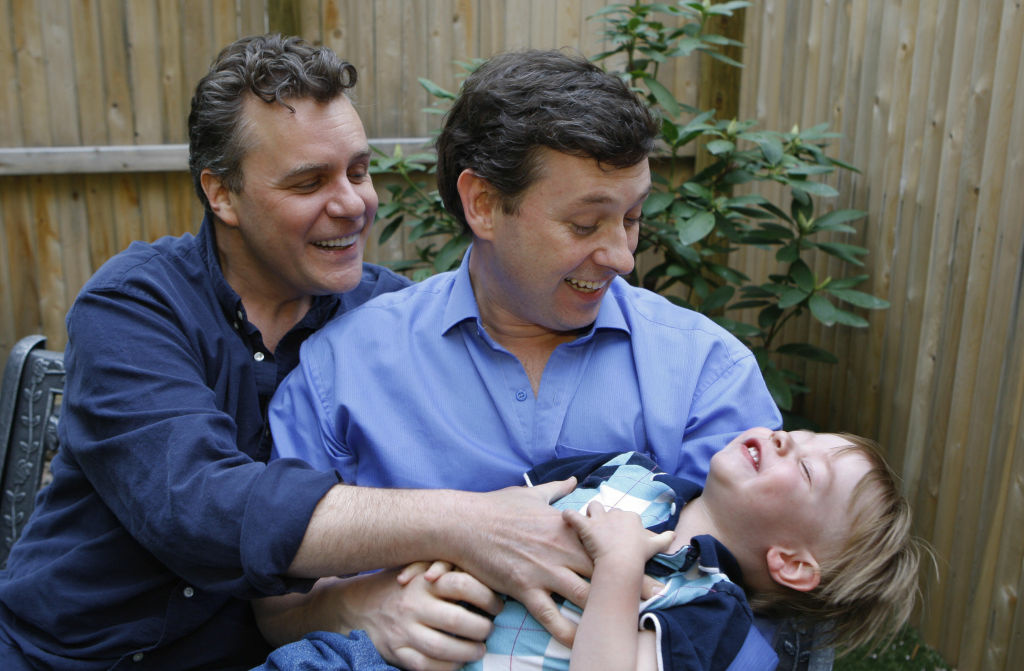 Gay couple Jeffrey Parsons (R) and Chris Gay couple Jeffrey Parsons (R) and Chris Hietikko pose with their son Henry Hietikko-Parsons in the garden of their house in New York on May 01, 2008. Henry was conceived by the couple via artificial insemination and a surrogate mother.Surrogates, who are paid about $20,000 above and beyond medical expenses to carry a child, are responsible for approximately 1,000 births a year, according to the Organization of Parents Through Surrogacy, that records births brokered through agencies and privately over the Internet.