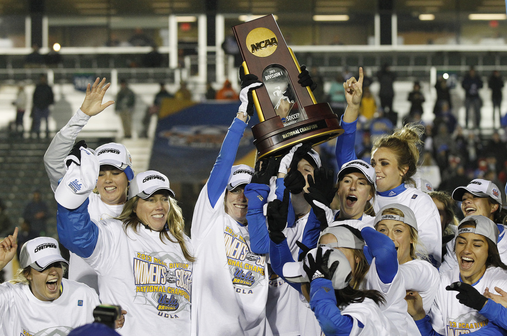 Womens College Cup UCLA players and head coach Amanda Cromwell, second from left, celebrate with the trophy after beating Florida State 1-0 during overtime in the championship soccer game at the NCAA Women's College Cup in Cary, N.C., Sunday, Dec. 8, 2013.