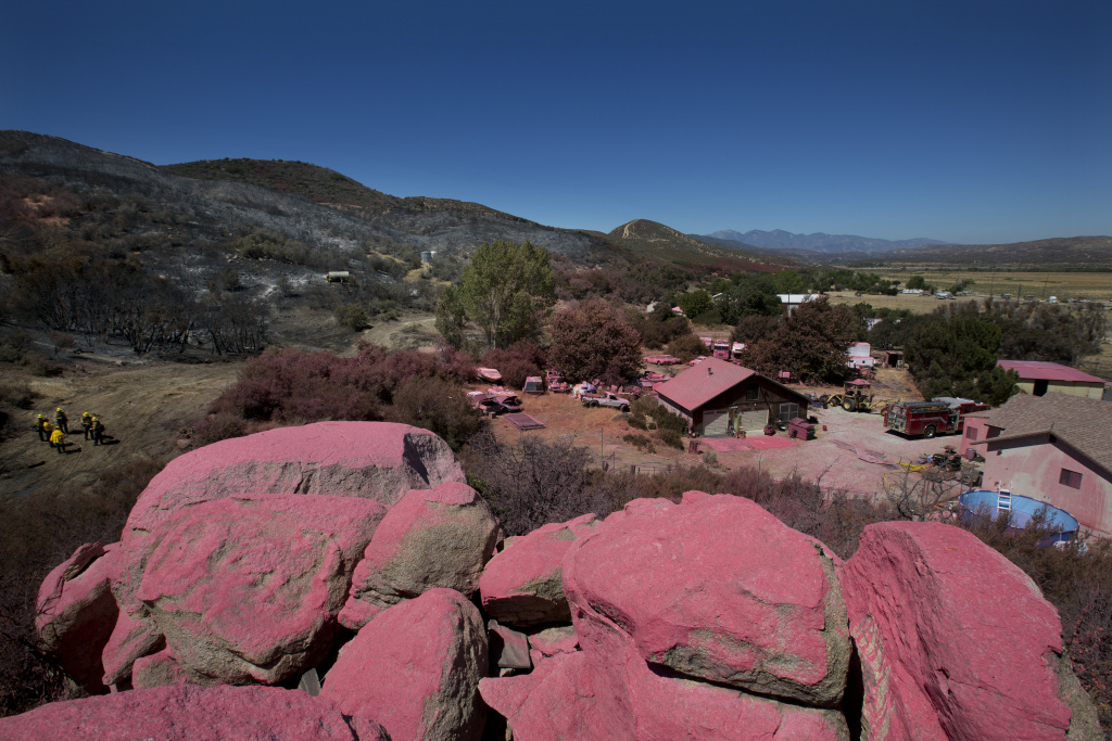Pilot Fire profile The San Bernardino National Forest team works on the Pilot Fire behind Ryan Nuckols’s home in Hesperia California on August 9th, 2016. The pink fire retardant line is one of the reasons why fire crews were able to save Nuckols’ house from the fire.