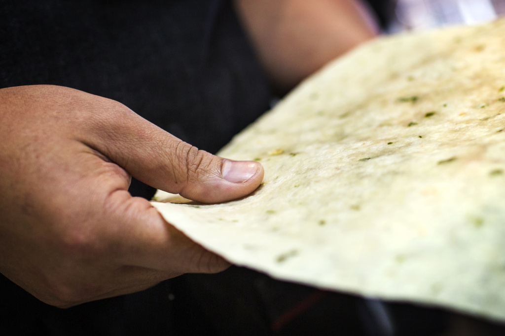 Panda Express - Inline - 1 Jimmy Wang, director of culinary innovation, holds a scallion pancake-inspired wrap he helped to develop at the Panda Express Innovation Kitchen in Pasadena. The pancake is about 12-and-a-half inches in diameter.