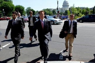Governor Arnold Schwarzenegger walks with his entourage after meeting with Health and Human Services Secretary Kathleen Sebelius near the US Capitol on May 20, 2009 in Washington, DC. Budget problems mean California lobbyists will soon have a decreased presence in the capital.