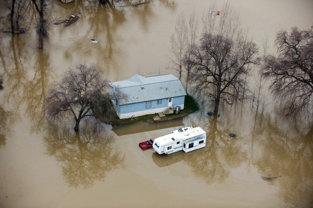 TOPSHOT-US-DAM-WEATHER A home is seen marooned as the surrounding property is submerged in flood water in Oroville, California on February 13, 2017.