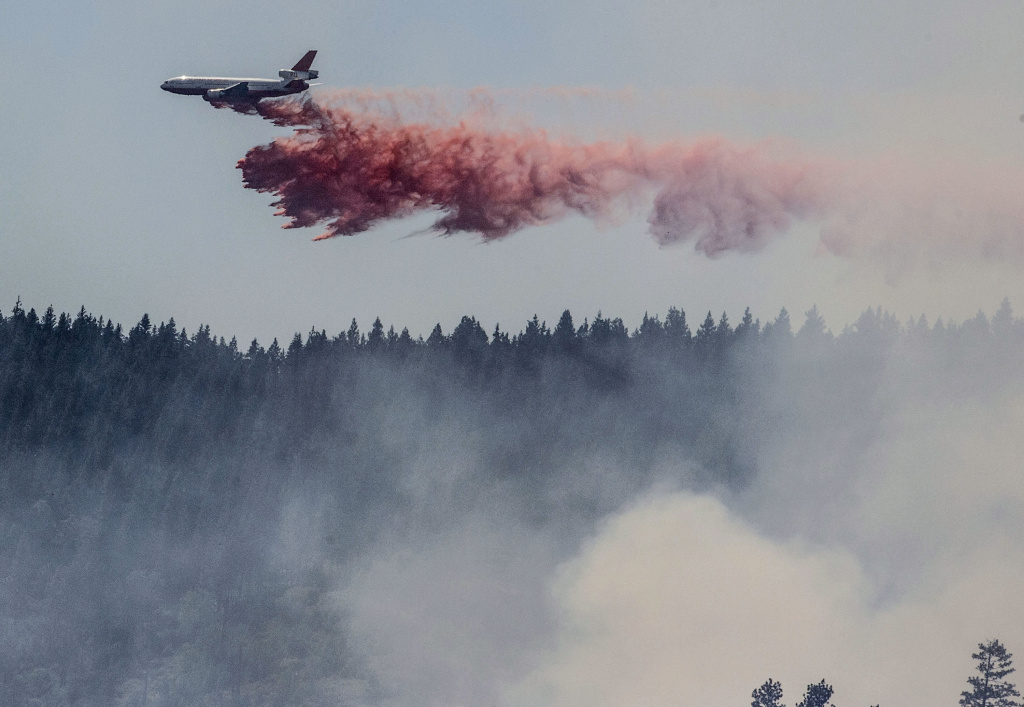 California Wildfires A plane drops fire retardant as firefighters battle a blaze in El Portal, Calif., near Yosemite National Park on Tuesday, July 29, 2014.
