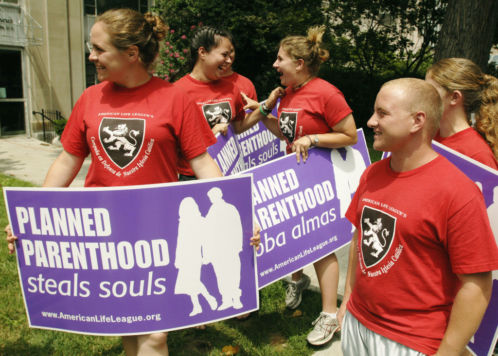 Anti-abortion activists cheers upon hearing news that they have been granted an audience with the Pope as they protest outside of a Planned Parenthood health clinic 28 July 2005 in Washington, DC. The group had walked from Maine,to Washington, DC protesting at pro-choice health clinics along the way.