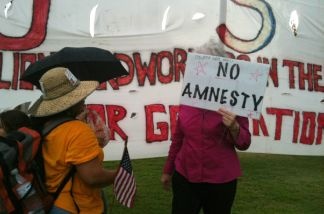 File photo: A supporter of SB 1070 engages in a conversation with Gloria Godoy, a Guatemalan American who came from Los Angeles to protest against Arizona's new immigration law.