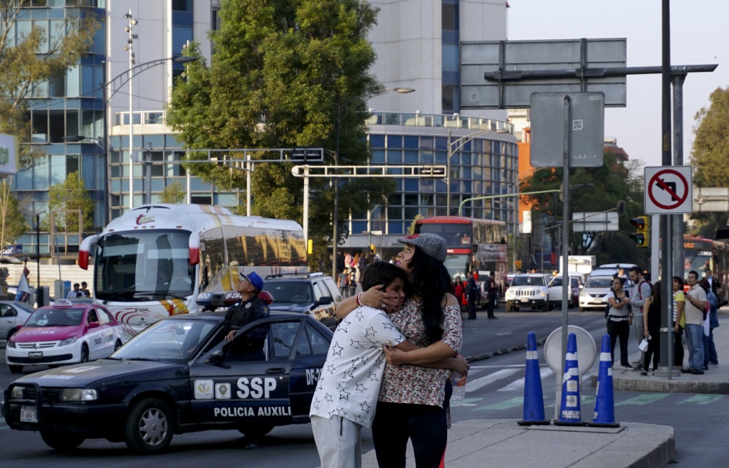 MEXICO-QUAKE A woman embraces a boy after a powerful earthquake rocked Mexico City on February 16, 2018.