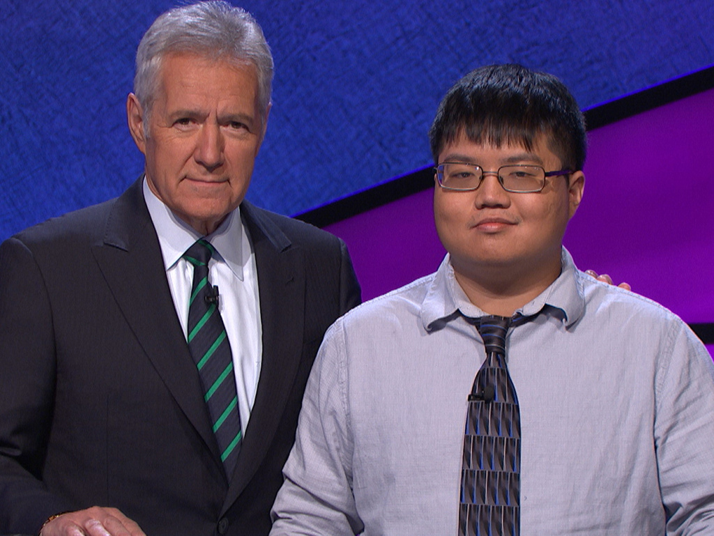 Game show contestant Arthur Chu with host Alex Trebek on the set of <em>Jeopardy!</em>