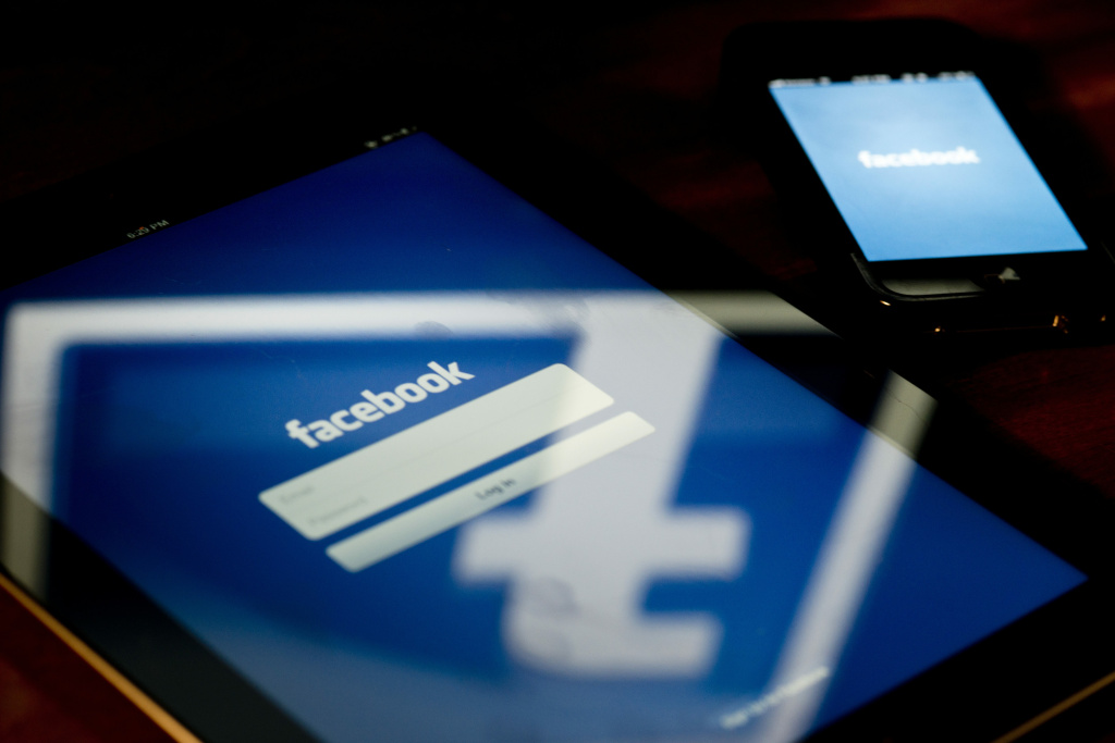 US-IT-COMPANY-STOCKS-IPO-INTERNET-FACEBOOK A view of an Apple iPad and iPhone displaying the Facebook app's splash screen.