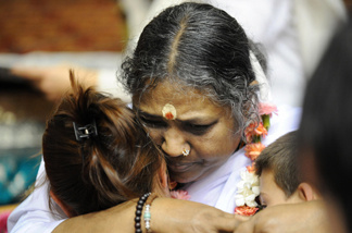 Indian spiritual leader Mata Amritanandamayi, or Amma (Mother) as she is known (C) hugs people on October 23, 2008 in Cergy-Pontoise, outside Paris during a few days trip in France. Amma, revered as a saint by her followers and a widely respected humanitarian, offers a hug to everyone who approaches her. Worldwide, Amma is said to have hugged at least 30 million people in the past 30 years.