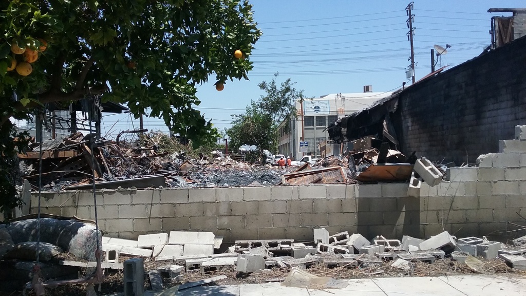 Maywood Fire The cinder block wall that separated Yesenia Jaramillo's Maywood yard from a metal recycler was blown out by the massive fire that began June 14.
