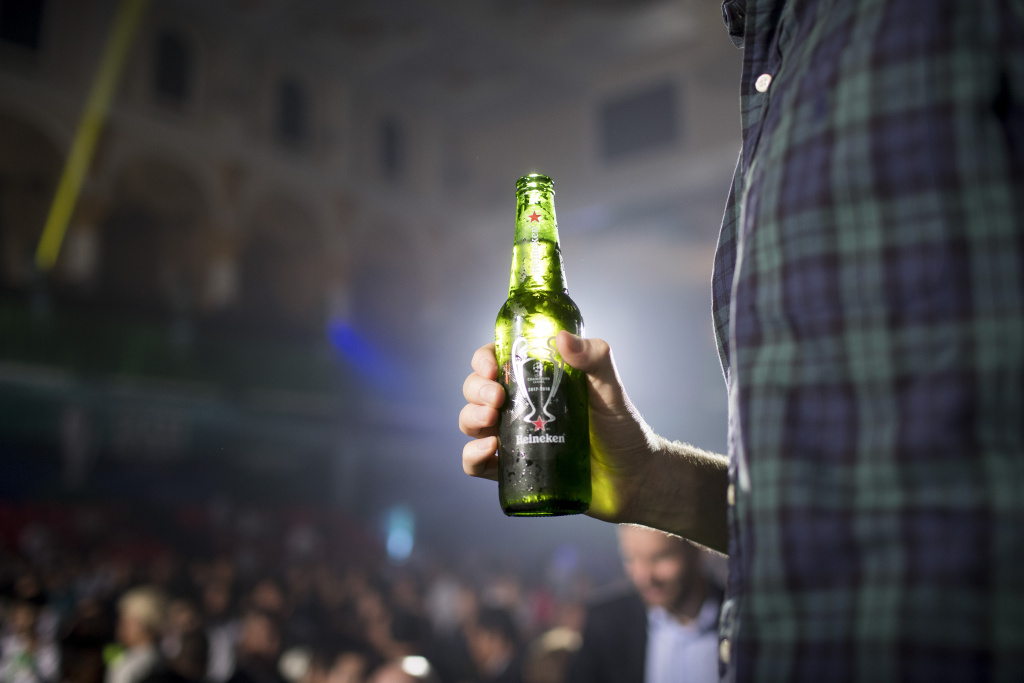 UEFA Champions League Trophy Tour presented by Heineken - Phnom Penh A man holds a bottle of beer during the UEFA Champions League Trophy Tour on April 3, 2017 in Phnom Penh, Cambodia.