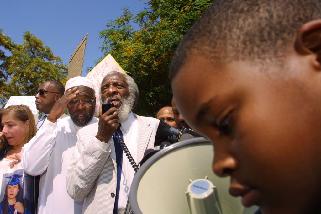US civil rights activist Dick Gregory (2nd L) addr Civil rights activist Dick Gregory addresses protestors on July 12, 2002 in Inglewood, California. Demonstrators were calling for action against police in a videotaped incident in which a police officer is shown apparently smashing 16-year-old Donovan Jackson's head into a car, then striking him in the face.