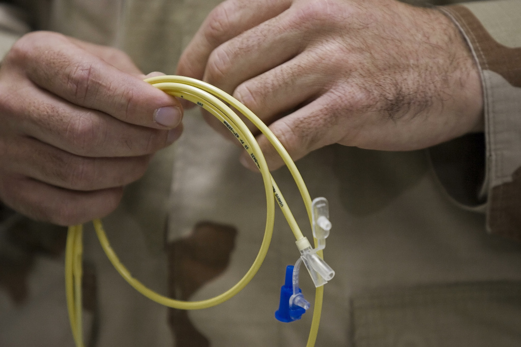 Captain Ronald Sollock, Medical Joint Fo, feeding tube Guantanamo Bay, CUBA: Captain Ronald Sollock, Medical Joint Force HQ Surgeon holds one of the 'feeding tubes' currently used on three of detainees not eating as a form of protest at Camp Delta 05 December 2006 on the US Naval base at Guantanamo Bay, Cuba. Approximately 445 enemy combatants from al Qaeda and the Taliban are in various security levels of lock-up here by a US Joint Task Force. AFP Photo/Paul J. Richards (Photo credit should read PAUL J. RICHARDS/AFP/Getty Images)