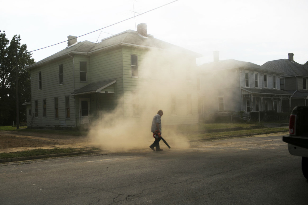 Tony Smith cleans an empty lot where a house once stood in Springfield. The city's population has fallen from more than 80,000 in the 1970s to less than 60,000 today. Tony Smith cleans an empty lot where a house once stood in Springfield. The city's population has fallen from more than 80,000 in the 1970s to less than 60,000 today.