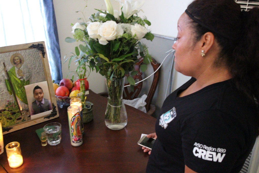 Boyle Heights OIS Teresa Dominguez, the mother of 14-year-old Jesse Romero, looks over a memorial for Romero, who was shot and killed by police in Boyle Heights on Aug. 9.