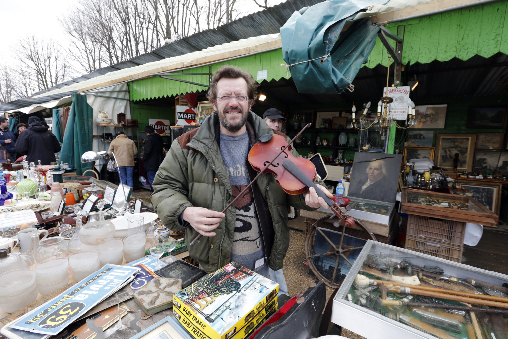 FRANCE-ANTIQUE-FAIR A man holds a violin on March 17, 2013 at the National Antiques and Ham Fair in the western Paris suburb of Chatou.