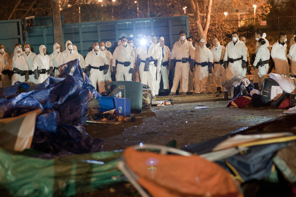 Los Angeles Police Move In To Evict Occupy LA Encampment Members of the Los Angeles Hazmat team prepare to clean the park in front of City Hall in downtown in the early hours of November 30, 2011 in Los Angeles, California.