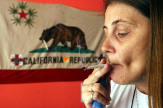 Mercer 9092 Staarla Heaney smokes a marijuana cigarette in front of the California state flag at the San Francisco Patients Cooperative, a medical cannabis cooperative, July 25, 2002 in San Francisco, California. A San Francisco city supervisor has drafted a proposal allowing voters in San Francisco to decide whether the city should consider getting into the marijuana growing business. Supervisor Mark Leno said he drafted the proposal because the Drug Enforcement Administration remains determined to close down clubs that distribute medical marijuana in San Francisco and other parts of California.
