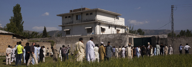 Pakistanis along with international and local media gather outside the compound in the city of Abbottabad where Osama bin Laden was killed during a raid by U.S. special operations forces.