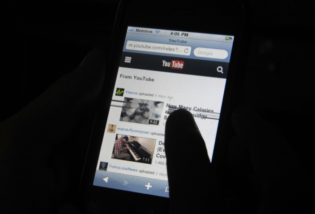 youtube phone smartphone A Pakistani cell phone user browses YouTube on his mobile phone in Quetta on December 29, 2012.