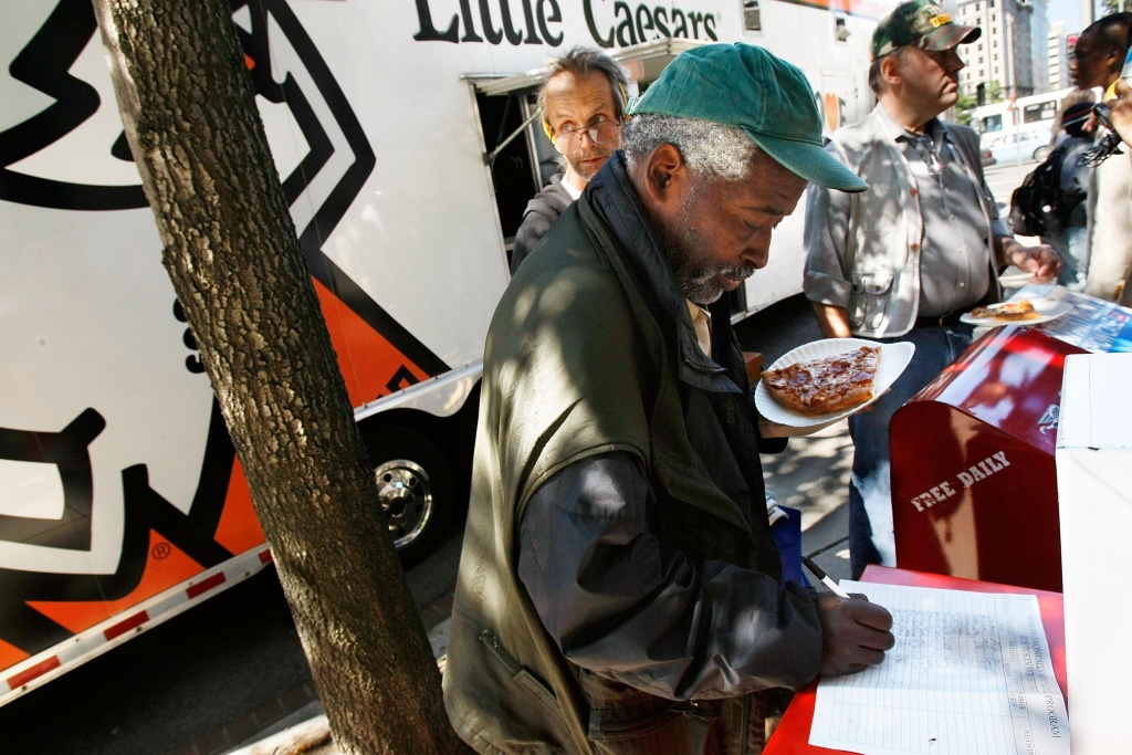 Veterans Secretary, Entrepreneur Feed Homeless Vets Former Army Sgt. Dennis Anderson, a homeless veteran, signs up as he gets a slice of pizza that was handed out from the Little Caesars Love Kitchen, a mobile pizza kitchen, in front of the Department of Veterans Affairs building September 17, 2007 in Washington, DC. The Love Kitchen was in town to provide hot pizza meals to homeless people including homeless veterans. Little Caesar's founder Michael Ilitch was awarded with the Secretary's Award Monday by the Department of Veterans Affairs to recognize his support of veterans.
