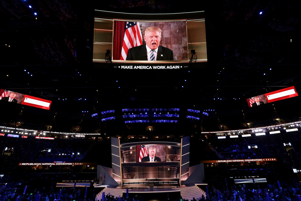 Republican National Convention: Day Two CLEVELAND, OH - JULY 19: Republican presidential candidate Donald Trump is seen speaking on a screen from New York City, on the second day of the Republican National Convention on July 19, 2016 at the Quicken Loans Arena in Cleveland, Ohio. Republican presidential candidate Donald Trump received the number of votes needed to secure the party's nomination. An estimated 50,000 people are expected in Cleveland, including hundreds of protesters and members of the media. The four-day Republican National Convention kicked off on July 18. (Photo by Alex Wong/Getty Images)