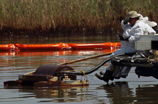 Contract workers from BP use skimmers to clean oil from a marsh near Pass a Loutre on June 1, 2010 near Venice, Louisiana.