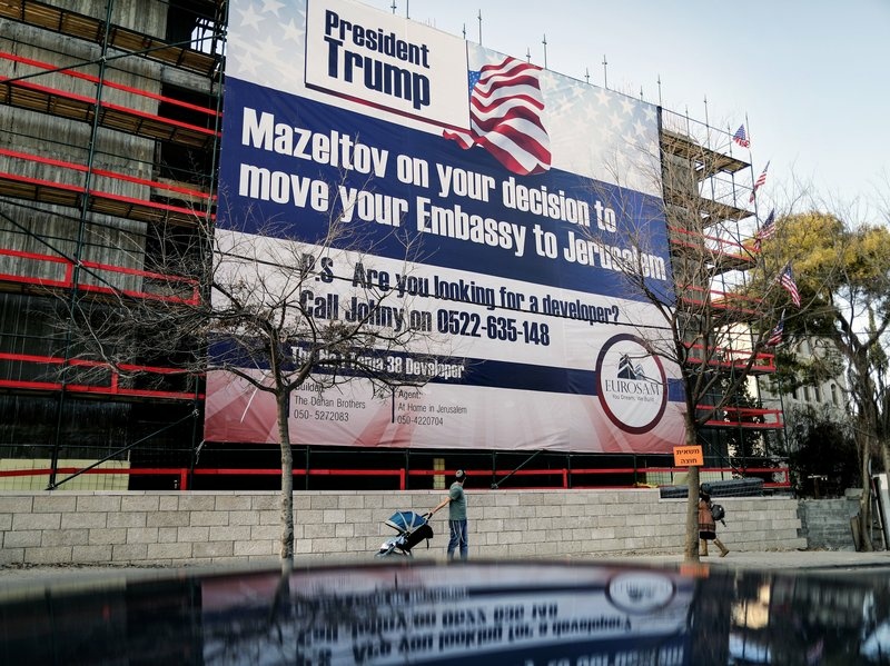 On a building under construction in Jerusalem, a banner bears a message of congratulations for Trump, along with an offer of work. On a building under construction in Jerusalem, a banner bears a message of congratulations for Trump, along with an offer of work.