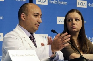 Emily Fennelll, who lost her right hand in an auto accident in 2006, listens as Dr. Kodi Azari, surgical director of the UCLA Hand Transplantation Program, describes Fennell's surgery at a news conference at UCLA Medical Center on April 19, 2011.