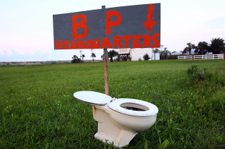 A sign left by the side of the road points to a toilet on May 30, 2010 near Grand Isle, Louisiana.