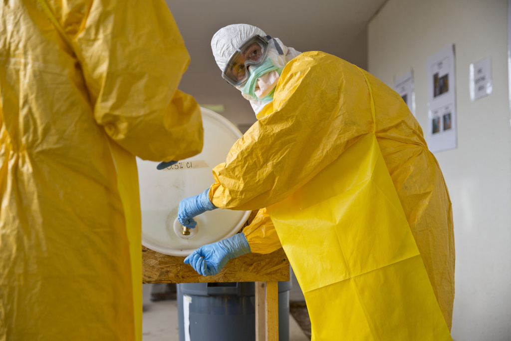 CDC EBOLA TRAINING A licensed clinician sanitizes his hands after a simulated training session on Monday, Oct. 6, 2014, in Anniston, Ala. The Centers for Disease Control and Prevention (CDC) has developed an introductory training course for licensed clinicians. According to the CDC, the course is to ensure that clinicians intending to provide medical care to patients with Ebola have sufficient knowledge of the disease. (AP Photo/Brynn Anderson)