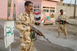 Members of the Sunni Awakening guard a checkpoint in the northern Iraqi city of Samarra in August. The former insurgents joined the U.S. in the fight against al-Qaida and are credited with helping turn the course of the war.