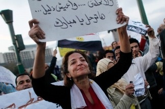 Mercer 14364 An Egyptian woman holds up a sign in Tahrir Square during afternoon anti-government protests January 31, 2011 in central Cairo, Egypt. USC graduate student Mohamed Saleh's wife Rania is among the protesters gearing up for a massive action Tuesday.
