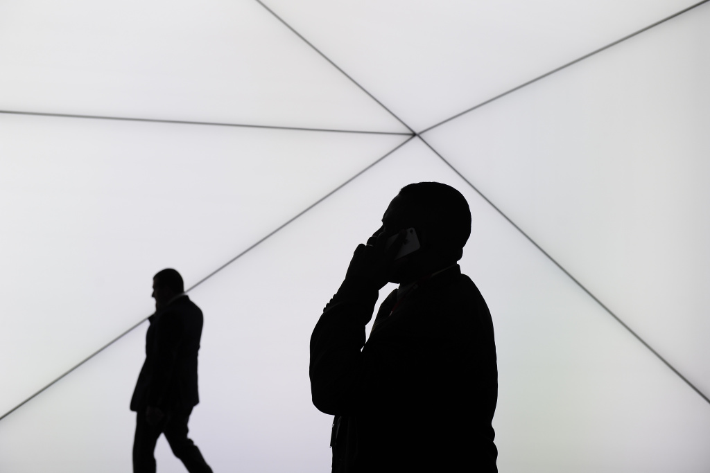 SPAIN-TELECOM-MOBILE-WORLD-CONGRESS Caption:A visitor speaks on his phone in Barcelona on February 25, 2014, on the second day of the 2013 Mobile World Congress.