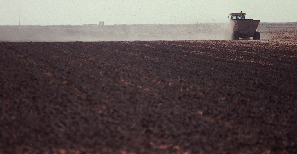 Treated sewer sludge is spread over a field owned by Shaen Magen, near Corcoran, California. If it weren't for the constant shipments of human waste from Southern California's cities, Kern County farmer Shaen Magen says his farm would dry up and blow away.